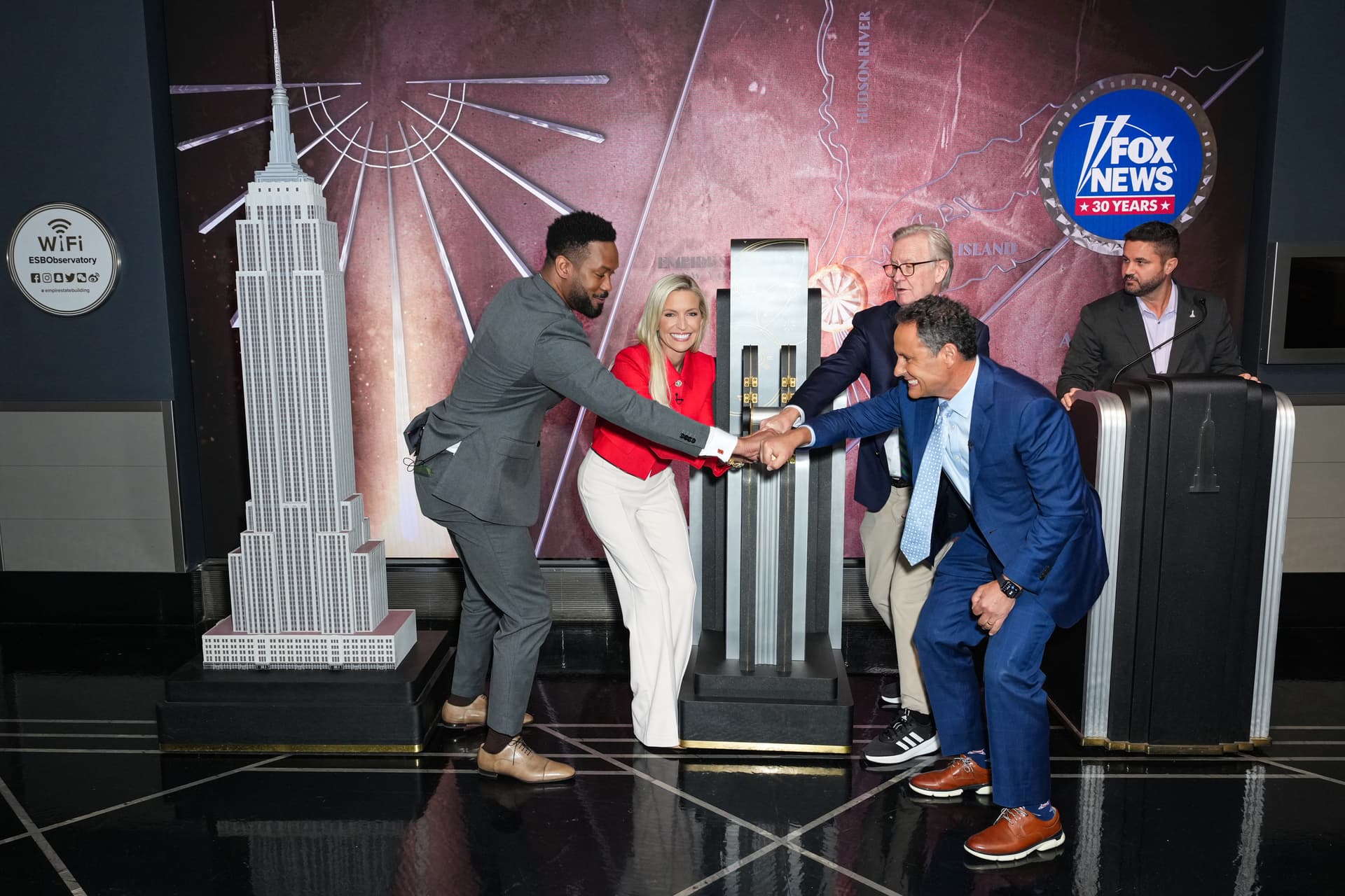 Steve Doocy, Ainsley Earhardt, Brian Kilmeade and Lawrence Jones light the Empire State Building